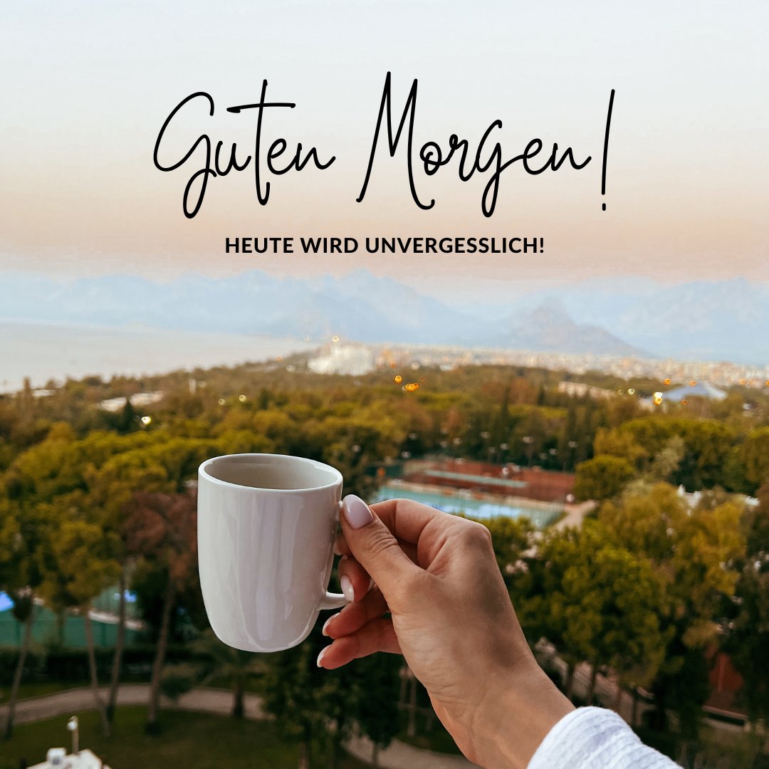 Einen Schönen Guten Morgen Bilder mit einer Hand, die eine weiße Kaffeetasse hält, vor einer atemberaubenden Aussicht auf Berge und Stadt im Morgenlicht, einladend zu einem unvergesslichen Tag.