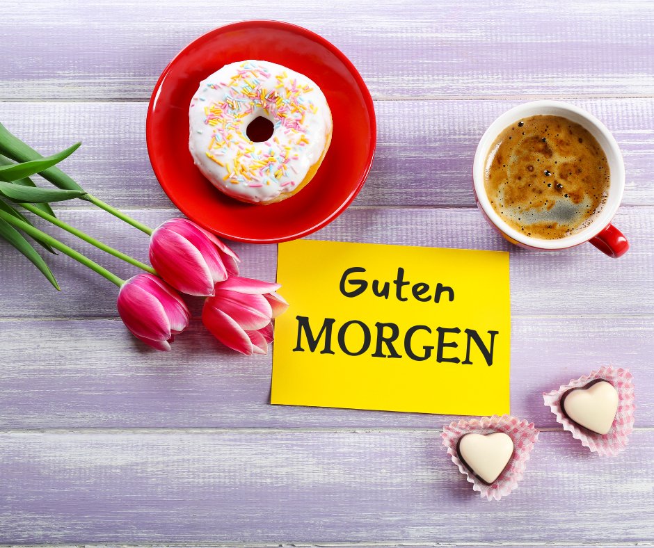 Einen Schönen Guten Morgen Bilder mit einer Tasse Kaffee, einem Donut auf einem roten Teller, rosa Tulpen und einem gelben Grußkärtchen mit der Aufschrift „Guten Morgen“, perfekt für einen süßen und fröhlichen Start in den Tag.